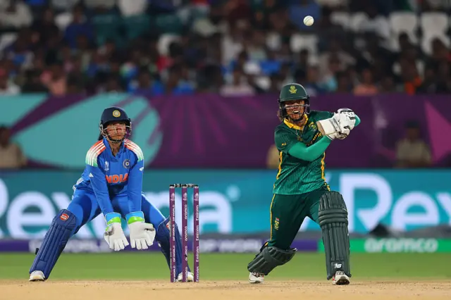 Chloe Tryon of South Africa bats as wicket keeper Richa Ghosh