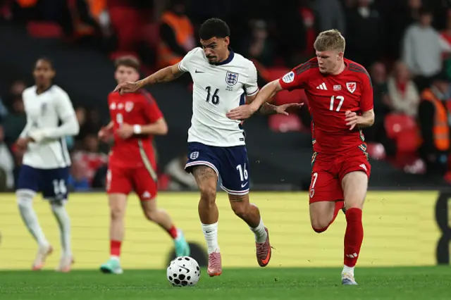 Morgan Gibbs-White of England and Jordan James of Wales battle for possession