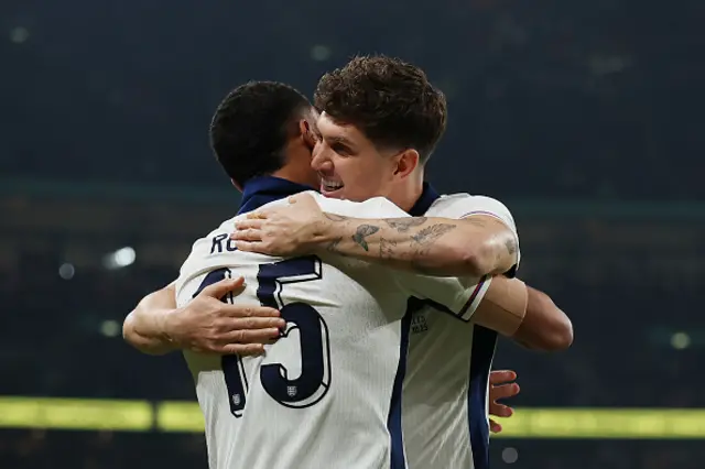 Morgan Rogers of England celebrates with teammate John Stones