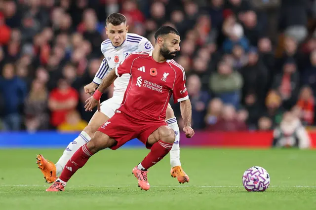 Mohamed Salah of Liverpool battles for possession with Lucas Digne of Aston Villa during the Premier League match between Liverpool and Aston Villa at Anfield on November 01, 2025 in Liverpool, England.