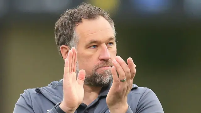 Grimsby boss David Artell applauding his supporters after a match.