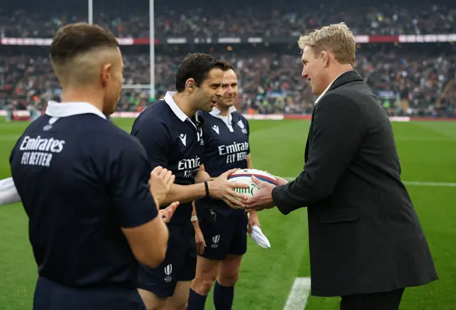 Former England international rugby player Lewis Moody presents the match ball to Referee
