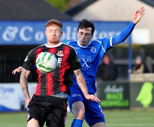 Bryden and Wallace battling for the ball