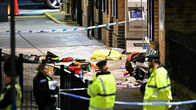 Paramedics medical equipment is pictured within a police cordon outside Huntingdon Station