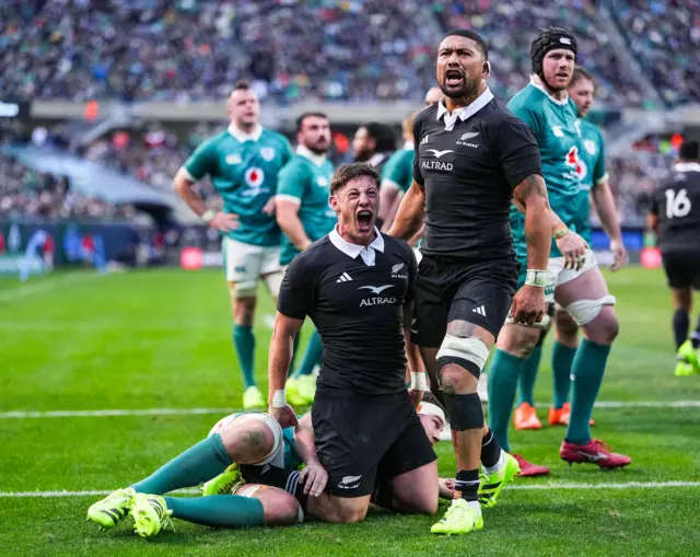 Cam Roigard celebrates scoring their fourth try with Ardie Savea