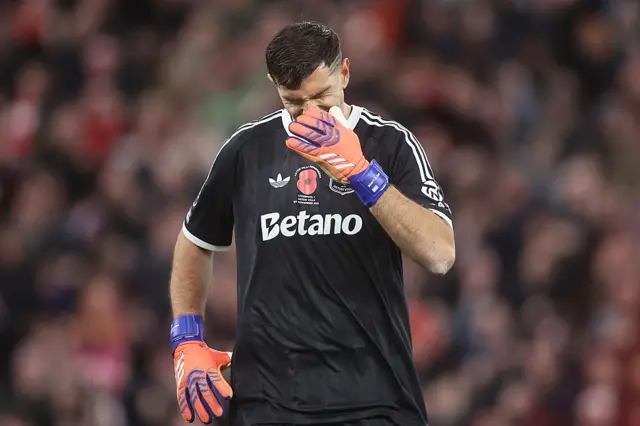 Emiliano Martinez of Aston Villa looks dejected after his mistake leads to Liverpool's first goal during the Premier League match between Liverpool and Aston Villa at Anfield on November 1, 2025 in Liverpool, England.