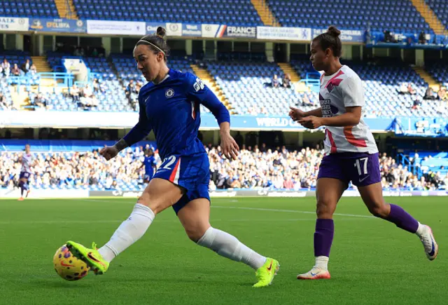 Lucy Bronze of Chelsea passes the ball whilst under pressure