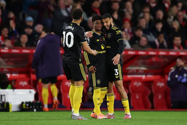 Amad Diallo of Manchester United celebrates scoring his team's second goal with teammates Noussair Mazraoui and Matheus Cunha during the Premier League match between Nottingham Forest and Manchester United at City Ground on November 01, 2025 in Nottingham, England. (Photo by Michael Regan/Getty Images)