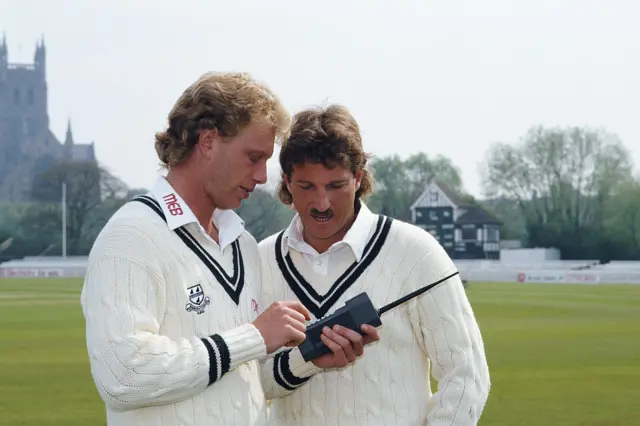 Ian Botham using an old mobile phone with Graham Dilley