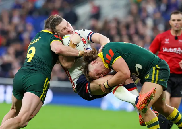 George Williams (C) of England in action with Harry Grant (L) and Reuben Cotter