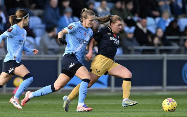 Manchester City's Vivianne Miedema (centre) and West Ham United's Oona Siren battle for the ball