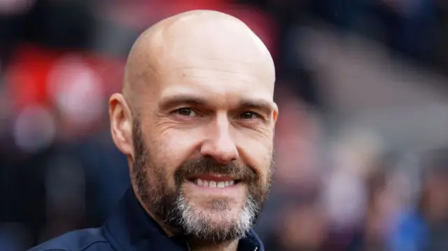 Luke Williams smiling from the touchline