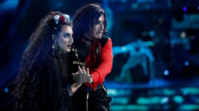 Two dancers in Halloween costumes