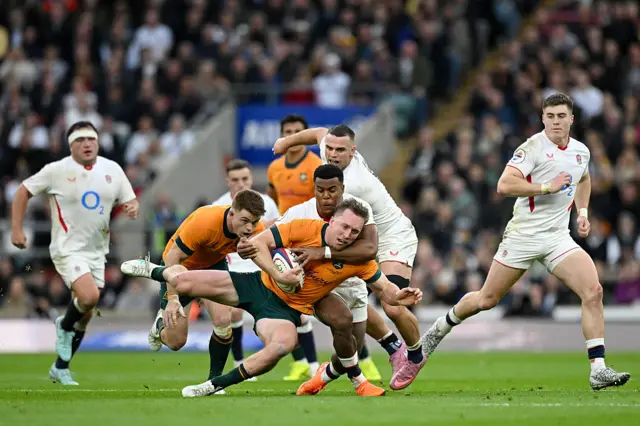 Immanuel Feyi-Waboso of England tackles Harry Potter of Australia