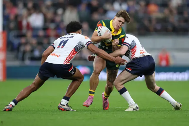 Australia's Reece Walsh is tackled by England's Harry Smith and Kai Pearce-Paul