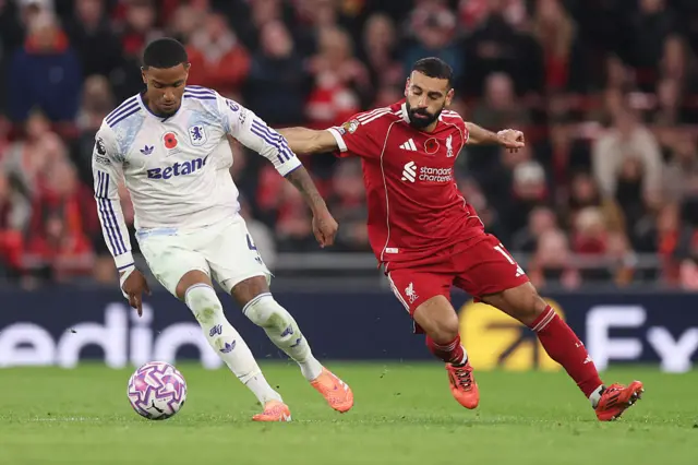 Ezri Konsa of Aston Villa is challenged by Mohamed Salah of Liverpool during the Premier League match between Liverpool and Aston Villa at Anfield on November 01, 2025 in Liverpool, England.