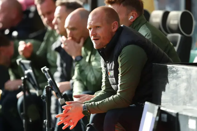 Liam Manning sitting on the bench