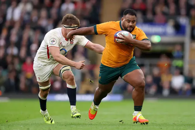 Taniela Tupou of Australia breaks away from Guy Pepper of England