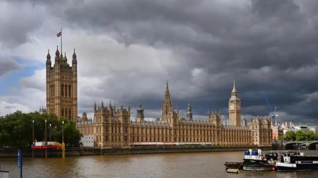 Grey clouds and dark skies above the Palace of Westminster