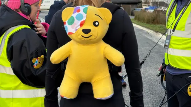 Sara with her back turned to the camera, wearing the Pudsey backpack.