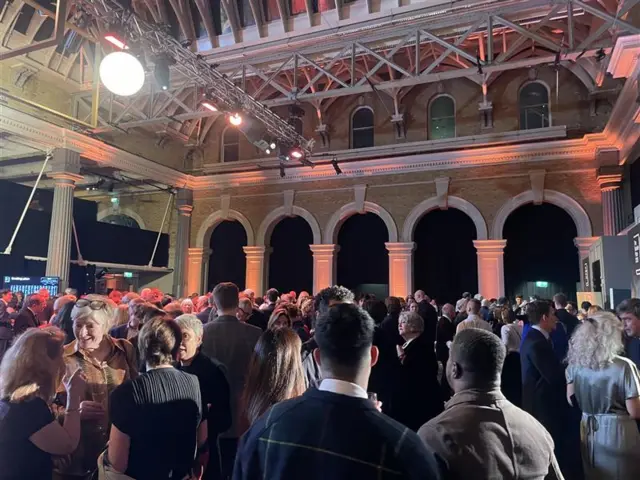 A crowd of people gathered inside Old Billingsgate