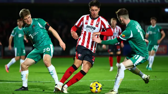 Isaac Hutchinson, of Cheltenham Town, takes on the Notts County defence
