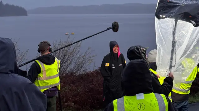 A smiling, rain-soaked Sara speaking to the BBC Breakfast crew.