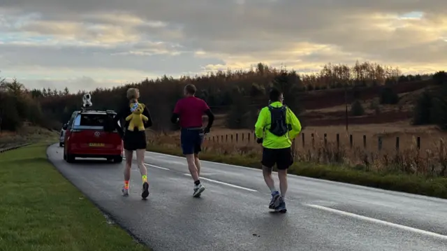 Sara on the move with 2 companions, wearing her pudsey backpack