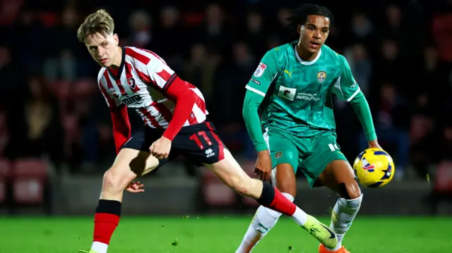 Jordan Thomas of Cheltenham Town and Tom Iorpenda of Notts County.