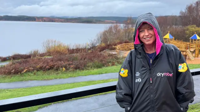 Sara stands in the rain waiting to begin her challenge