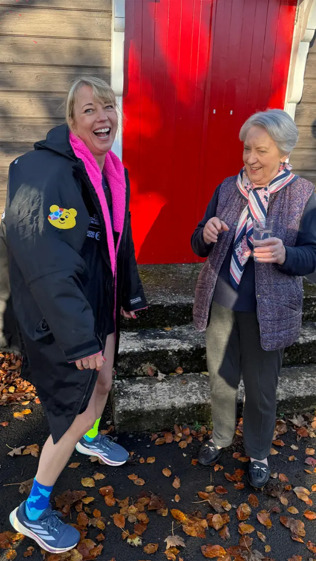 Anne Galbraith blessing Sara Cox's trainers with water from St. Cuthbert's Well