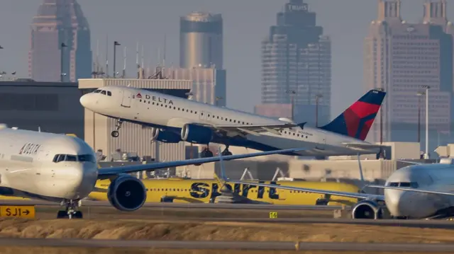 A Delta aircraft takes off from an airport in Atlanta.