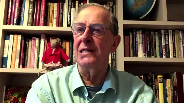 David Elstein speaks to the BBC, sat in front of a bookshelf filled with books