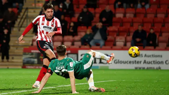 Isaac Hutchinson, of Cheltenham Town, scores against Notts County