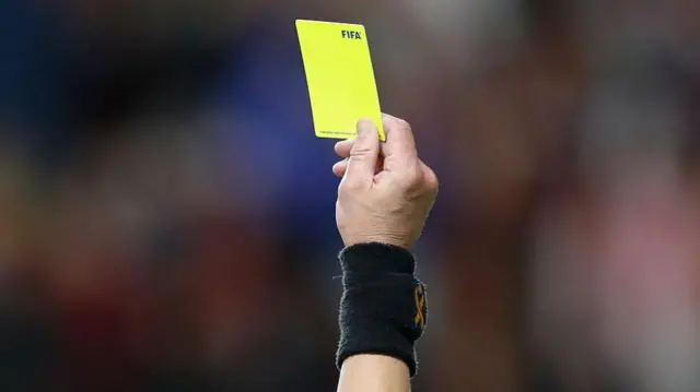 Referee Sergii Boiko gives a yellow card during the second half of the game between Real Salt Lake and Dallas FC