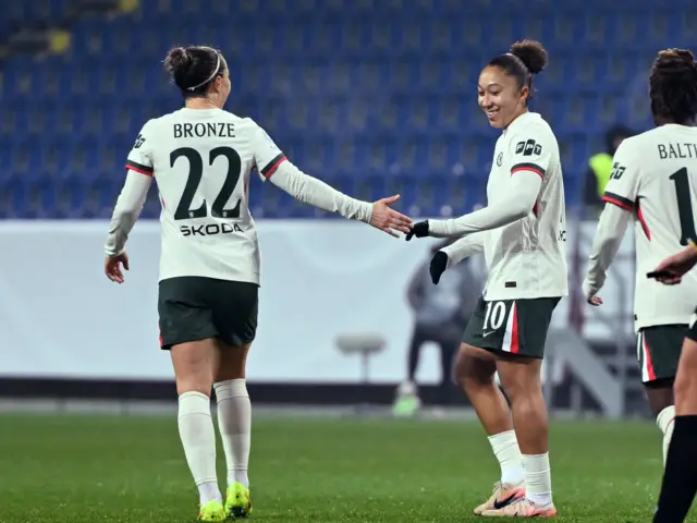 Chelsea's Lucy Bronze and Lauren James celebrate their fifth goal, an own goal scored by St. Polten's Lisa Ebert