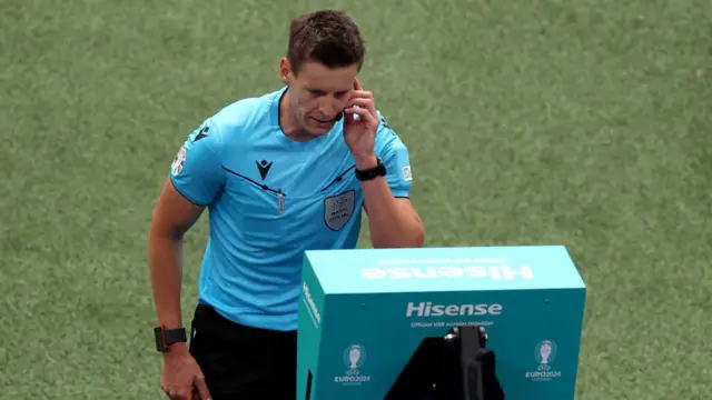 Referee Daniel Siebert checks the VAR screen