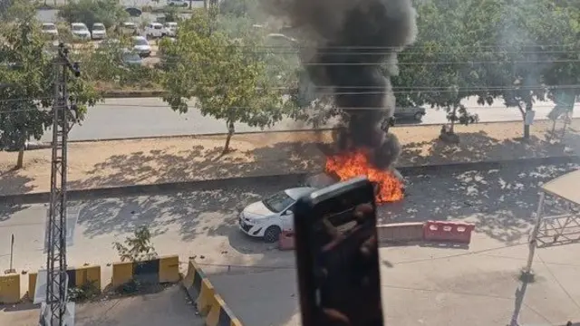 A screengrab from one of the videos showing the car burning outside the judicial complex in Islamabad