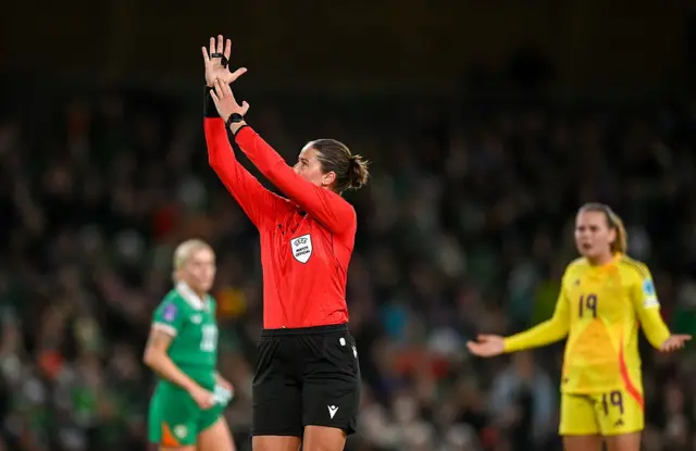Referee Franziska Wildfeuer signals for a handball resulting in a penalty for Republic of Ireland in a match against Belgium in the Women's Nations League