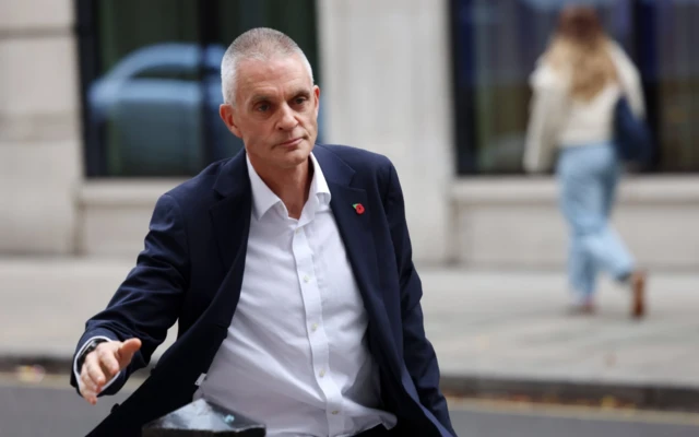 Outgoing BBC Director-General Tim Davie walks outside the BBC headquarters in London