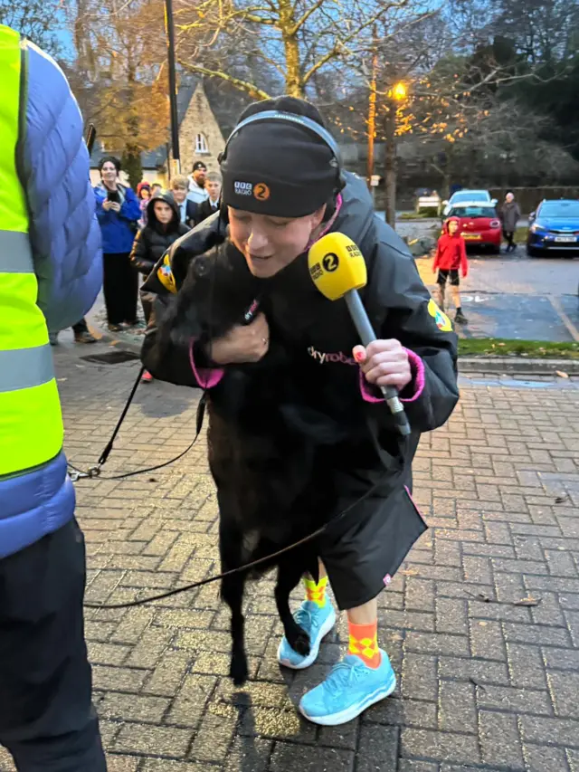 Sara is licked by her dog Daisy