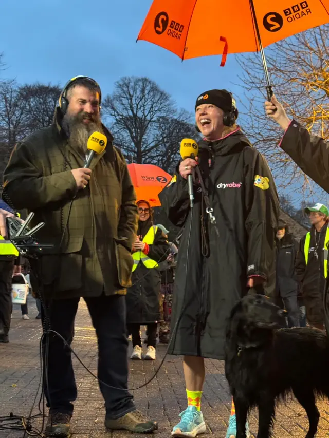 Sara beams next to her dog Daisy