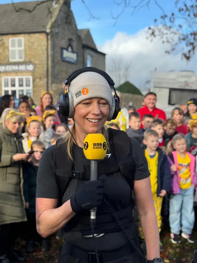 Sara smiles as she finds out she's reached over £1M in fundraising for Children in Need