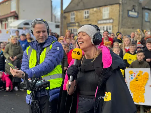 Sara smiles as she finds out she's reached over £1M in fundraising for Children in Need