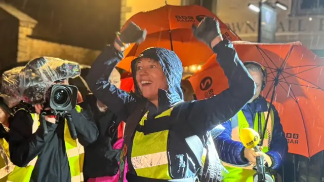 Sara raises her arms as she crosses the finish line in Richmond