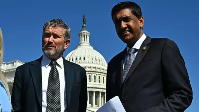 Representatives Thomas Massie and Ro Khanna stand together in front of the capitol