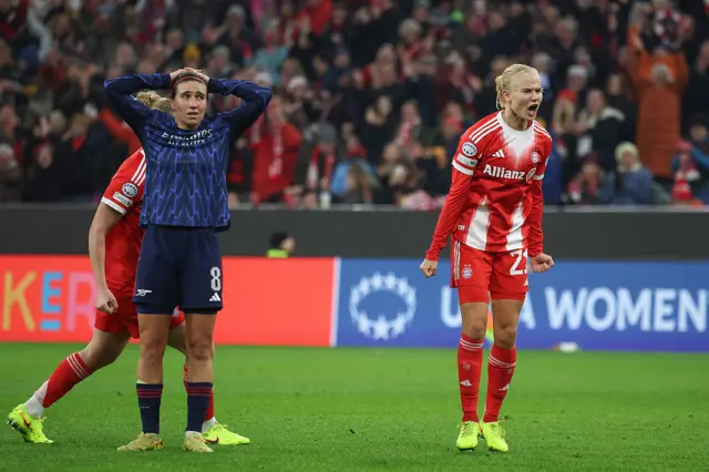 Bayern Munich's Danish forward #21 Pernille Harder (R) celebrates scoring the 2-2 goal next to Arsenal's Spanish midfielder #08 Mariona Caldentey