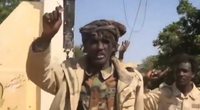 A RSF fighter raising his hand in celebration