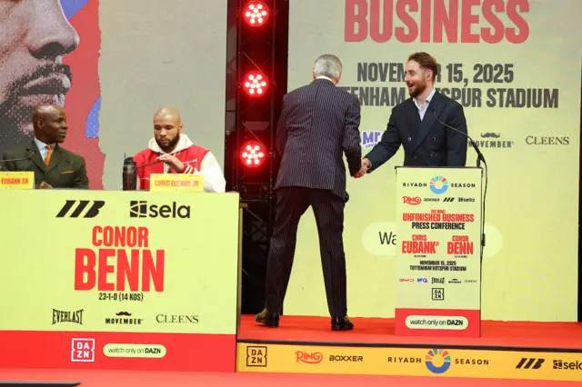 Chris Eubank Sr and Jr sit at the top table of a news conference