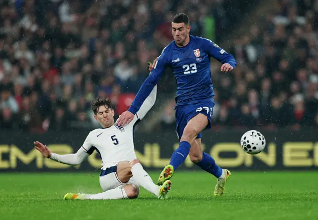 Dusan Vlahovic of Serbia is challenged by John Stones